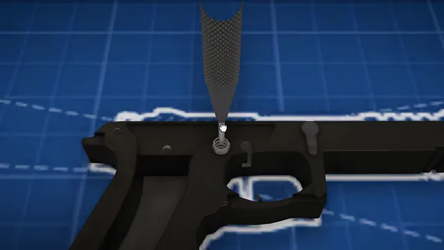 Spring pressed into a pistol frame on a blueprint
